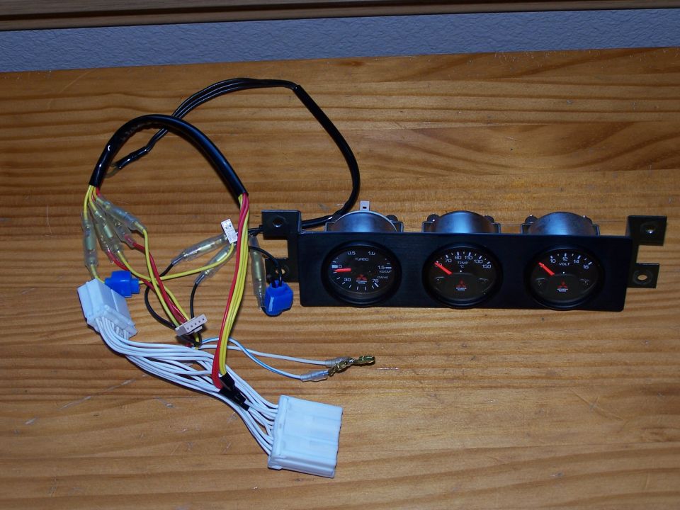 Aftermarket gauge cluster with turbo, temp, and volt gauges, and wiring harness