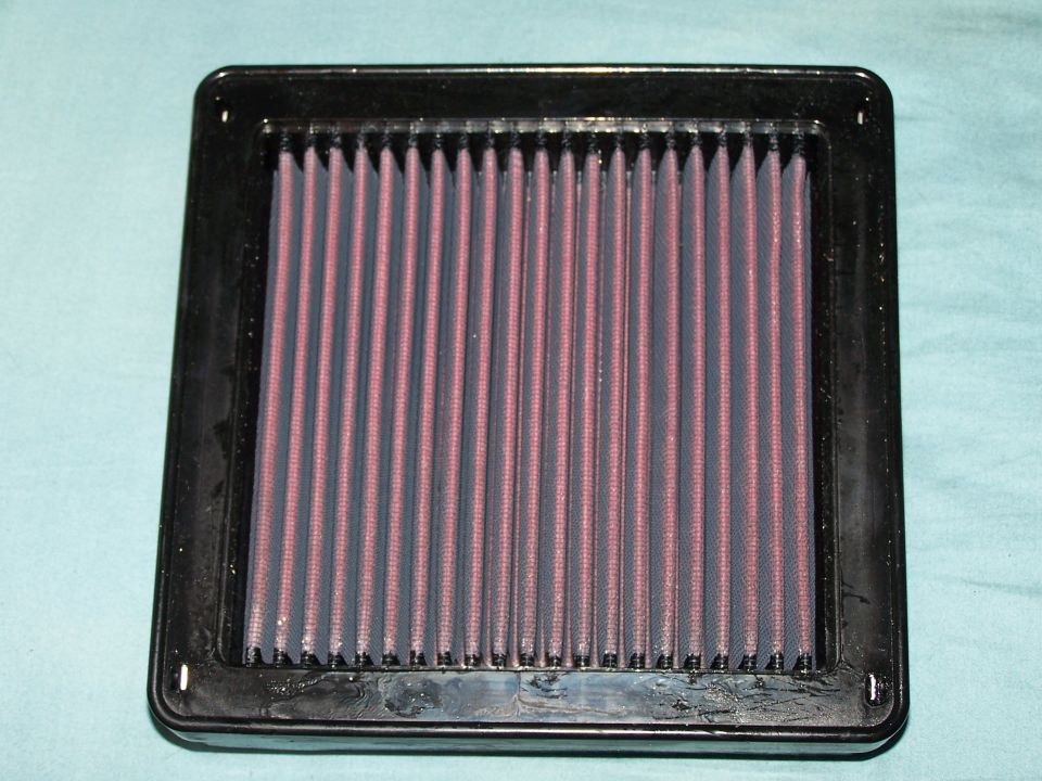 Black framed air filter with purple pleated filter material