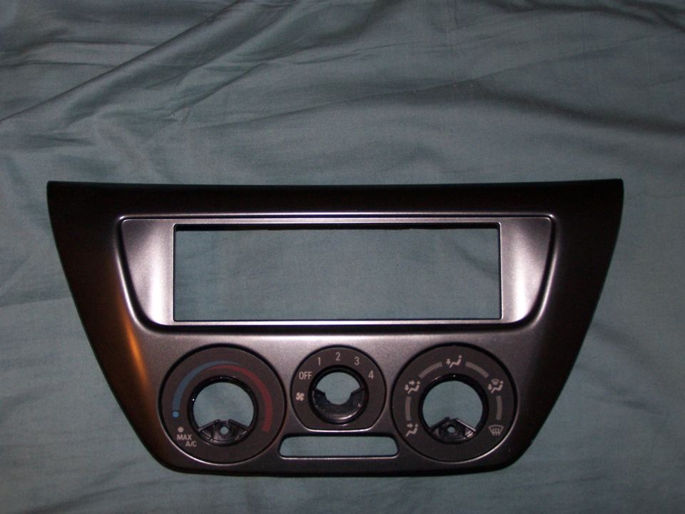 Dark gray dashboard trim with radio slot and climate control knobs