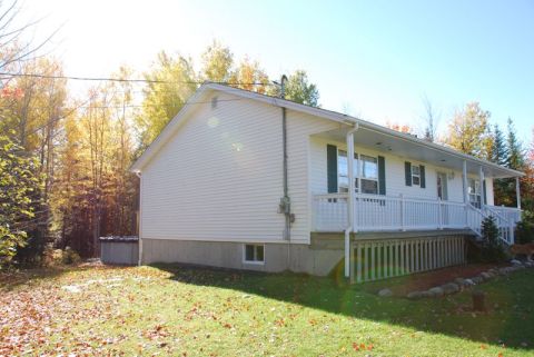 1996 Ford Bronco - Exterior view of a house during autumn, with colorful foliage visible in the background.