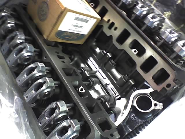 Engine intake manifold and rocker arms with a Ford branded box