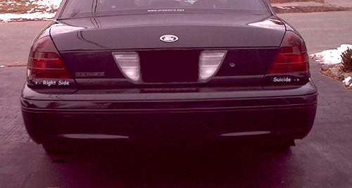 Rear of black Ford Crown Victoria with trunk labels reading Right Side and Suicide