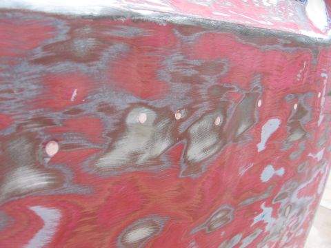 1979 Ford F-150 - This is a close-up of a vehicle's bodywork, showing areas that have been sanded and prepped for repair.