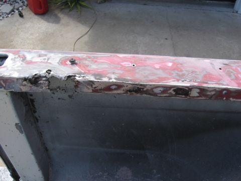 1979 Ford F-150 - The bed rail of a 1979 Ford F-150 shows significant rust damage and repair work.