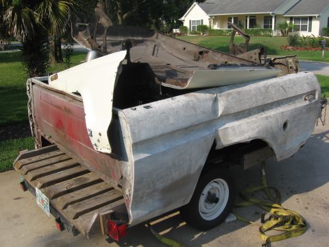 1979 Ford F-150 - Disassembled 1979 Ford F-150 truck bed and cab components are seen loaded onto a trailer.