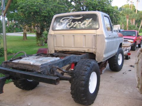 1979 Ford F-150 - Rear view of a 1979 Ford F-150 chassis and cab, with a second Ford pickup truck in the background.