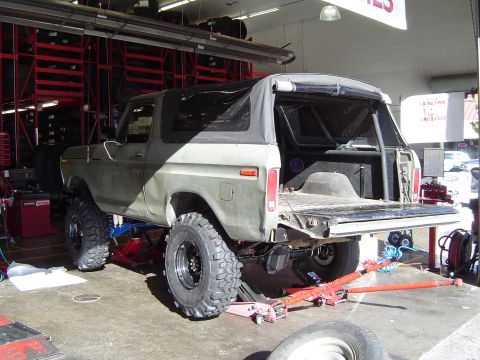 1978 Ford Bronco - This 1978 Ford Bronco is being worked on in a garage, showing its lifted suspension and large tires.