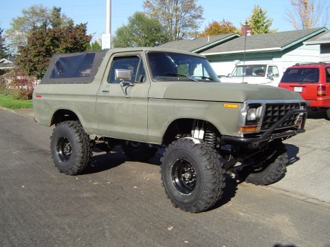 1978 Ford Bronco - Modified 1978 Ford Bronco with custom suspension and large tires parked on a street.