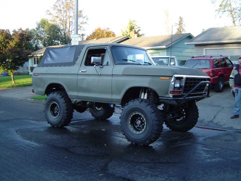 1978 Ford Bronco - This modified 1978 Ford Bronco features a soft top and large off-road tires, suggesting it's built for terrain.