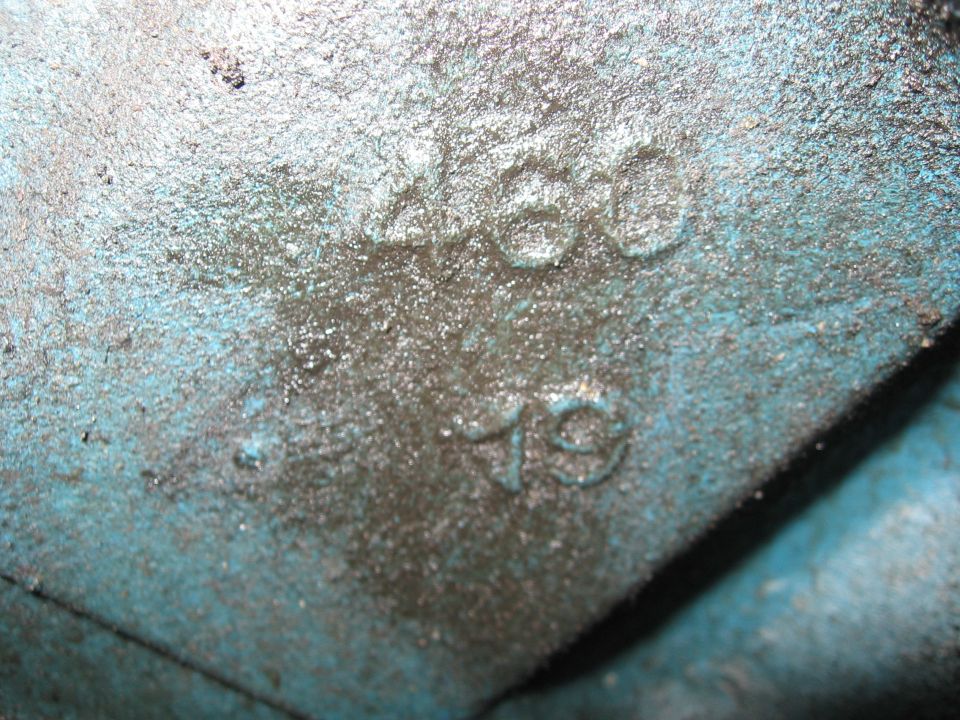 Close-up of a blue engine block casting with raised numbers '460' and '79'