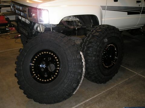 1986 Toyota Hilux - 1986 Toyota Hilux front end shown with two large off-road tires and beadlock wheels.