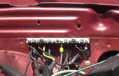 1997 Ford Taurus - Close-up of a vehicle's engine bay reveals a terminal block with numerous wires connected.