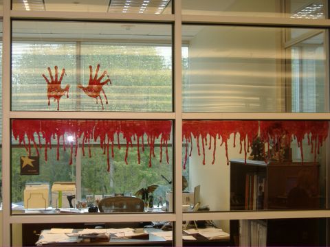 1991 Ford Bronco - Bloody handprints and drips decorate an office window, creating a crime scene illusion.