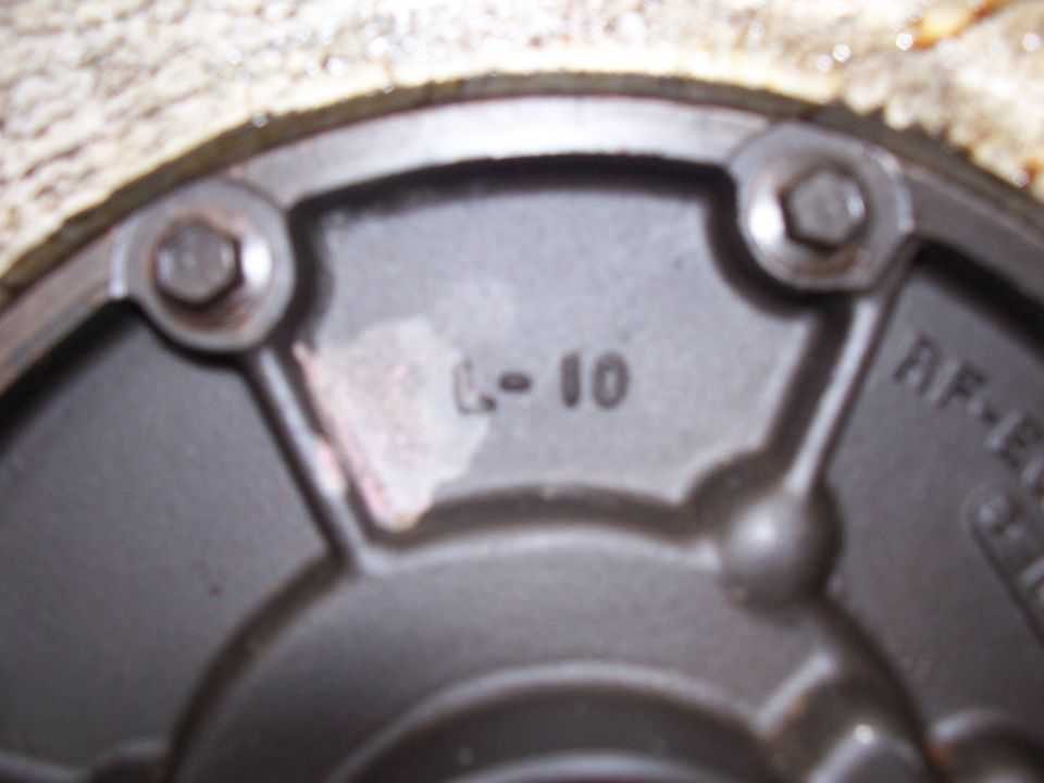 Close-up of a metal part with 'L-10' and 'AF-E' stamped on it