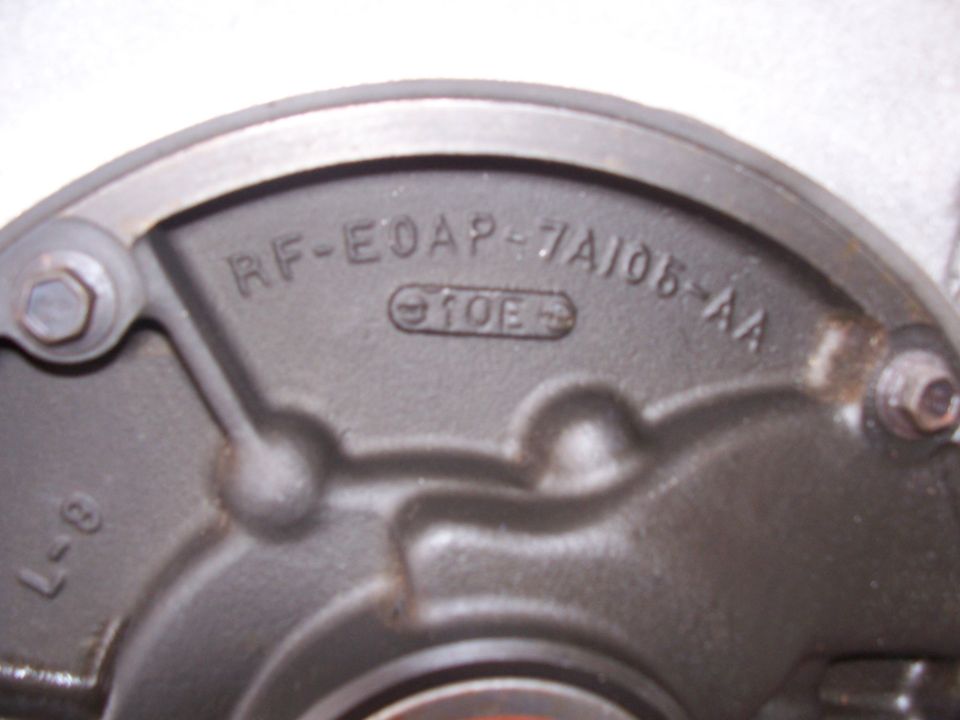 Close-up of a metal part with markings RF-EDAP-7A105-AA and 10E
