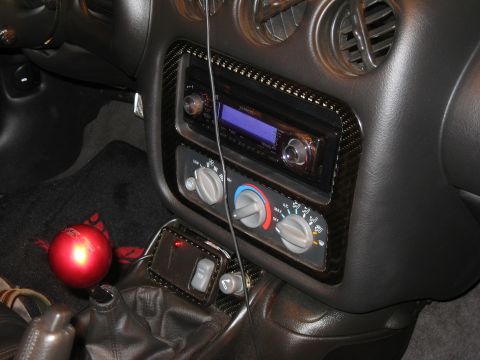 2002 Pontiac Trans Am - The interior of a 2002 Pontiac Trans Am shows an aftermarket stereo and carbon fiber trim around the center console.