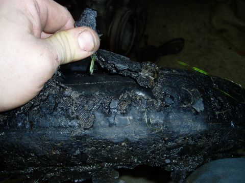 2000 Ford E350 - Close-up of a severely damaged tire, showing exposed cords and missing chunks of rubber.