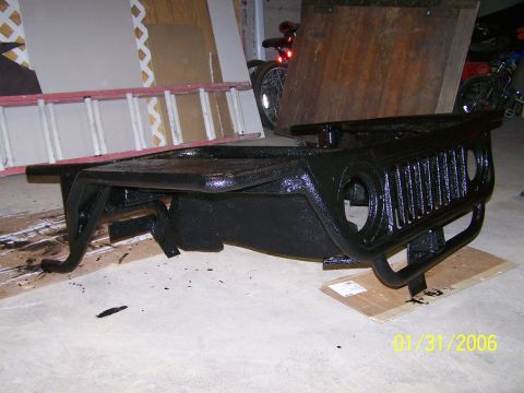 1988 Suzuki Samurai - A black Jeep grille and bumper assembly is shown, possibly being prepped for installation or after a paint job.
