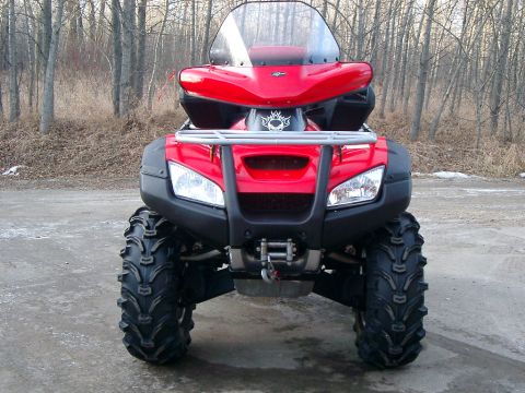 2004 Honda RINCON - This ATV is equipped with large tires for off-road use and has a windshield for rider protection.
