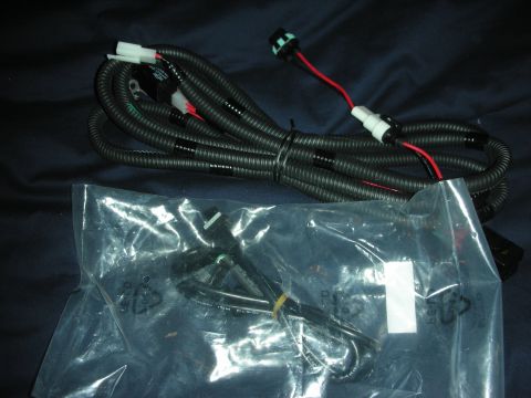 1998 Ford Crown Victoria - loomed black-and-red automotive wiring harness with plug connectors above a sealed bag containing a second harness.
