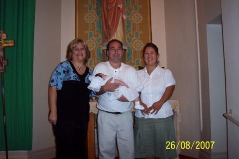 2000 Ford Crown Victoria - A family celebrates a baptism with a formal portrait taken in a church setting.