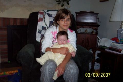 2000 Ford Crown Victoria - A woman holds a baby while sitting in a chair, with a timestamp indicating the photo was taken on March 9, 2007.