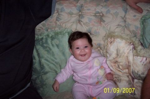 2000 Ford Crown Victoria - Baby smiling on a bed, dated 01/09/2007.