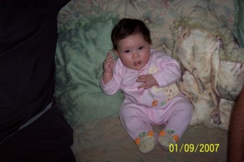 2000 Ford Crown Victoria - A baby is sitting on a couch with a date stamp of 01/09/2007.