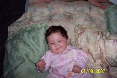 2000 Ford Crown Victoria - A baby smiles while lying on a bed, with a date stamp visible in the corner.
