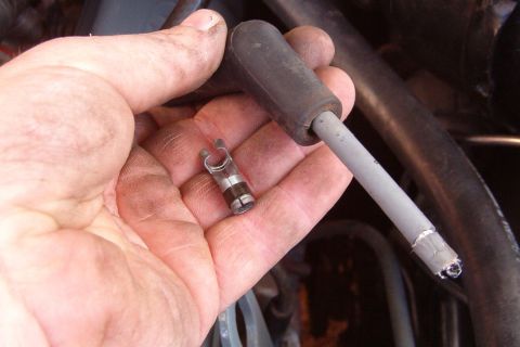 1983 Ford Bronco - Once the wire extends from the plug end of the boot a few inches, open the clamp section of the terminal to fit over the wire.