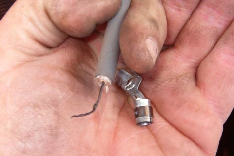 1983 Ford Bronco - Carefully remove the outer insulation from the end of the plug wire. Don't cut any more than necessary to get a good end on the insulation…