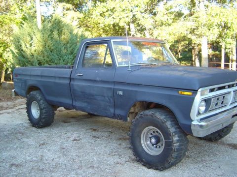 1986 Ford Bronco - This lifted pickup truck, likely a 1977 model based on its grille, is shown from a three-quarter front view.