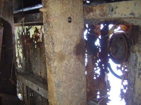 1986 Ford Bronco - The interior frame of a vehicle shows significant rust damage and deterioration.