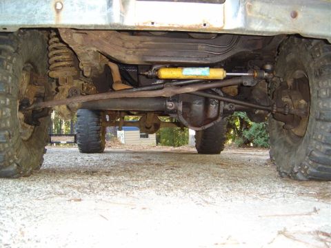 1986 Ford Bronco - The front suspension and steering system of a four-wheel-drive vehicle are shown from below.