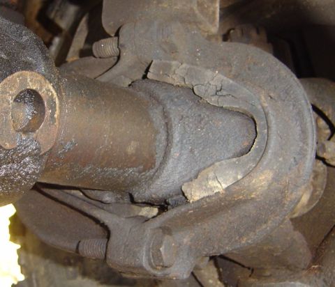 1986 Ford Bronco - Close-up of a cracked driveshaft u-joint boot, indicating wear and potential failure.