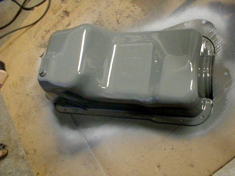 1996 Ford Bronco - A freshly painted gray oil pan sits on a surface, likely awaiting installation.