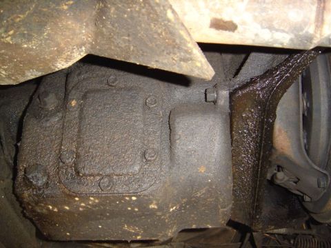 1986 Ford Bronco - Close-up view of a heavily greased vehicle component, likely part of the drivetrain.