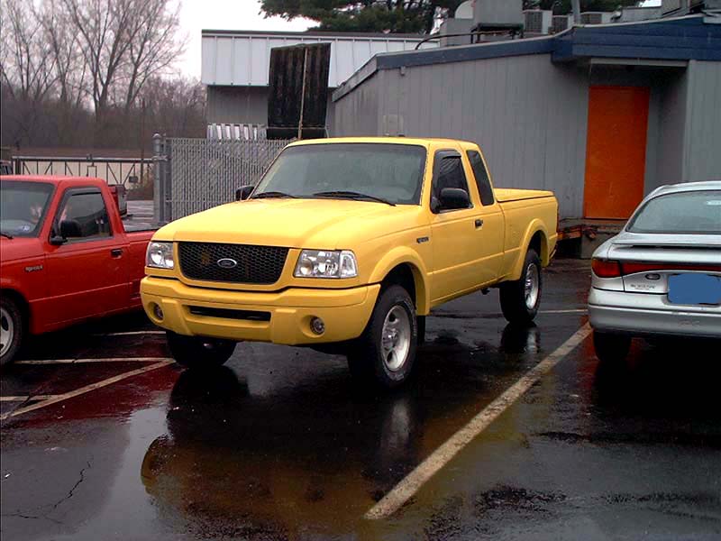 Yellow Ford Ranger pickup truck, 3q-front view