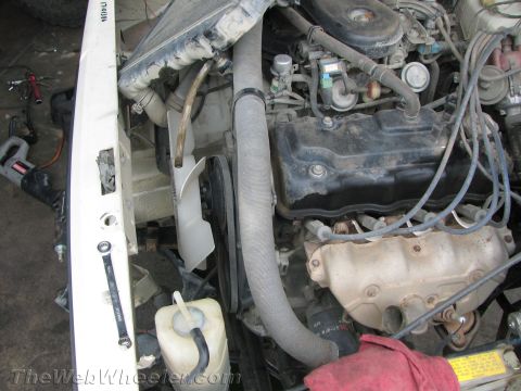 1987 Suzuki Samurai - Close-up view of a vehicle's engine bay, showing various components and hoses.