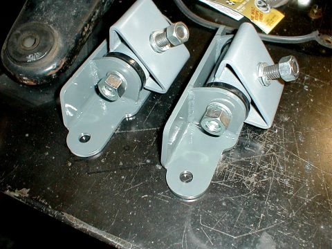 1996 Ford Bronco - Close-up view of two newly painted engine mounts, ready for installation.