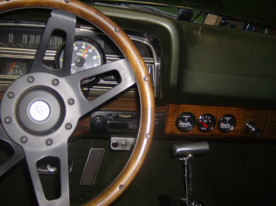 1970 Ford Ranchero interior with woodgrain trim, aftermarket steering wheel, and gauges