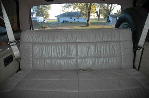 1995 Ford C-350 (Centurion Conversions) - View from the rear bench seat of a vehicle, showing the interior and the outdoor scenery.