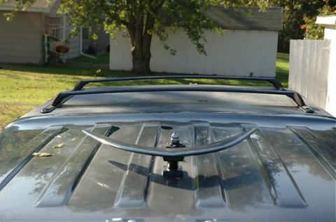 1995 Ford C-350 (Centurion Conversions) - Close-up of a roof rack and antenna mount on a vehicle's roof.