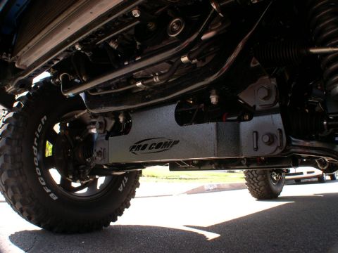 2007 Toyota FJ Cruiser - Underside view of a vehicle, highlighting aftermarket Pro Comp skid plates and off-road tires.