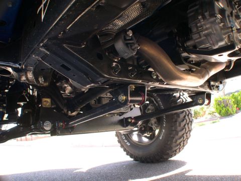 2007 Toyota FJ Cruiser - The underside of a vehicle is captured, showing the suspension, exhaust, and BFGoodrich tires. The Supermotors.net logo is visible.