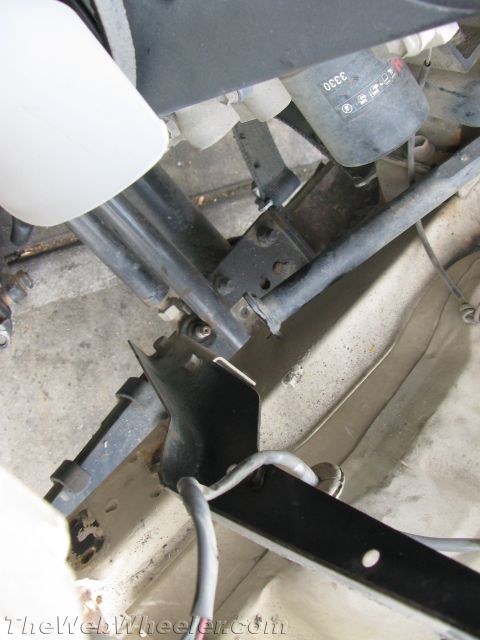1987 Suzuki Samurai - Close-up view of a vehicle's undercarriage, showing mechanical components and a black oil filter.