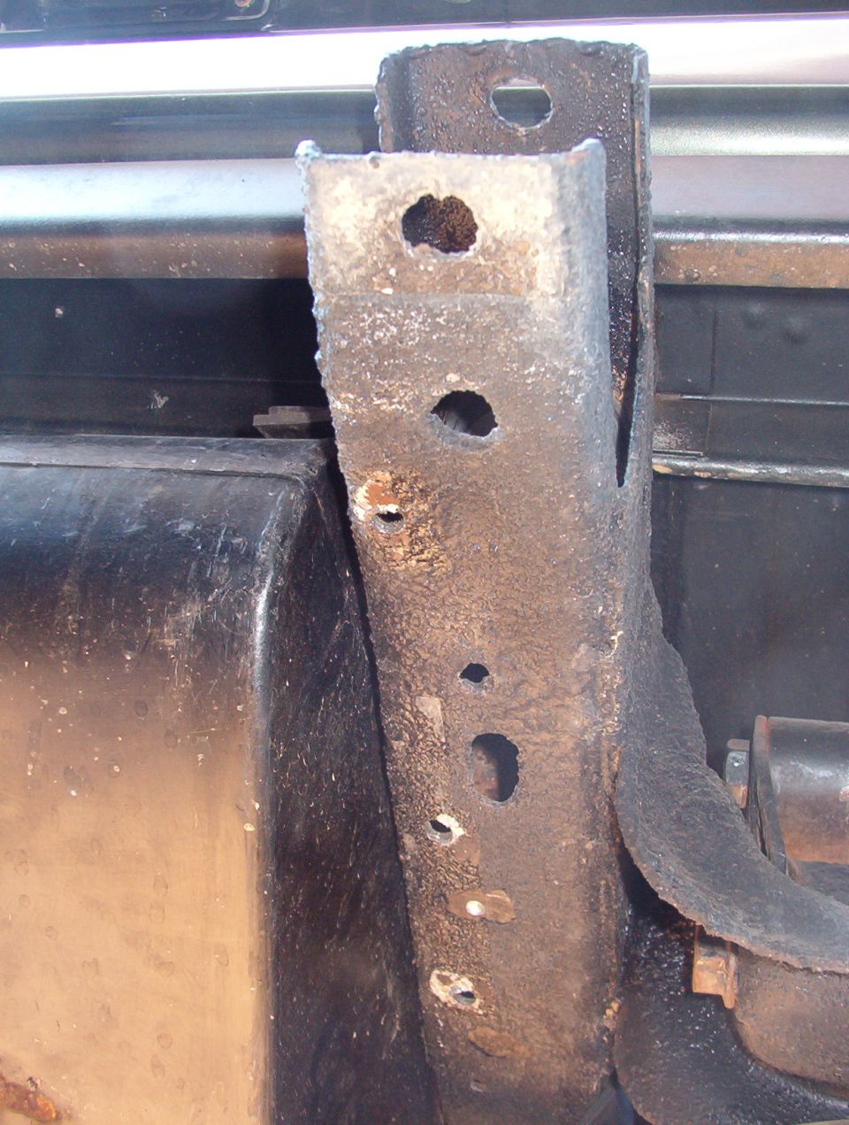 The 3 small threaded holes inboard are for the skidplate.  I'll only be using the rearmost one.