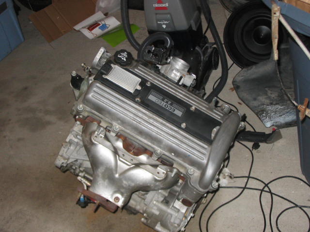 GM Ecotec 2.2 four-cylinder engine sitting out of the car on a garage floor