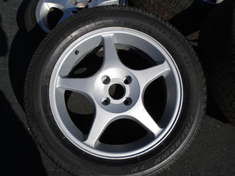 1979 Ford Bronco - A close-up view of a five-spoke alloy wheel mounted on a Firehawk tire, with the Supermotors.net logo visible at the bottom.