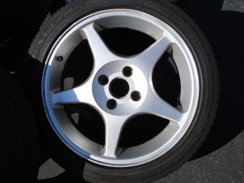 1979 Ford Bronco - A close-up view of a single alloy wheel and tire, with visible text on the tire sidewall.